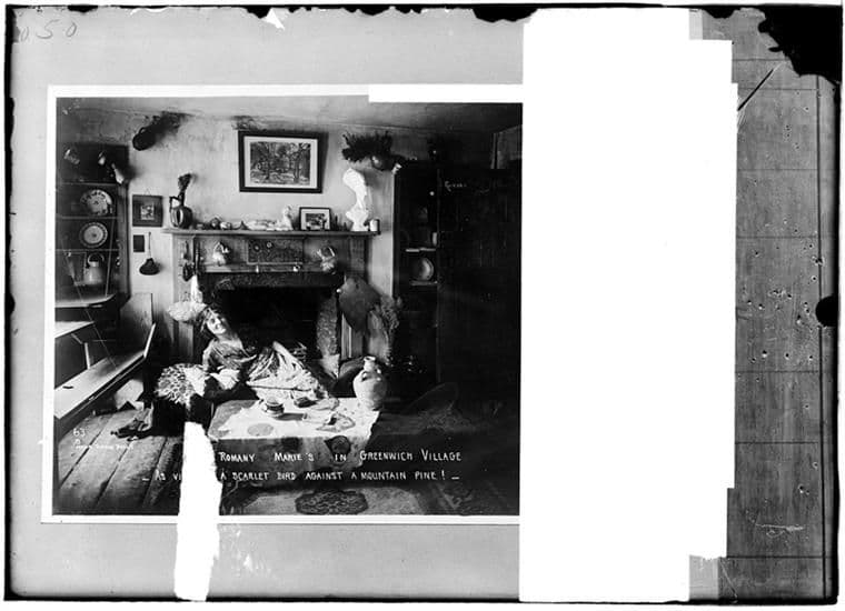 Romany Marie reclining beside a fireplace in her Greenwich Village tea room, photographed by Jessie Tarbox Beals