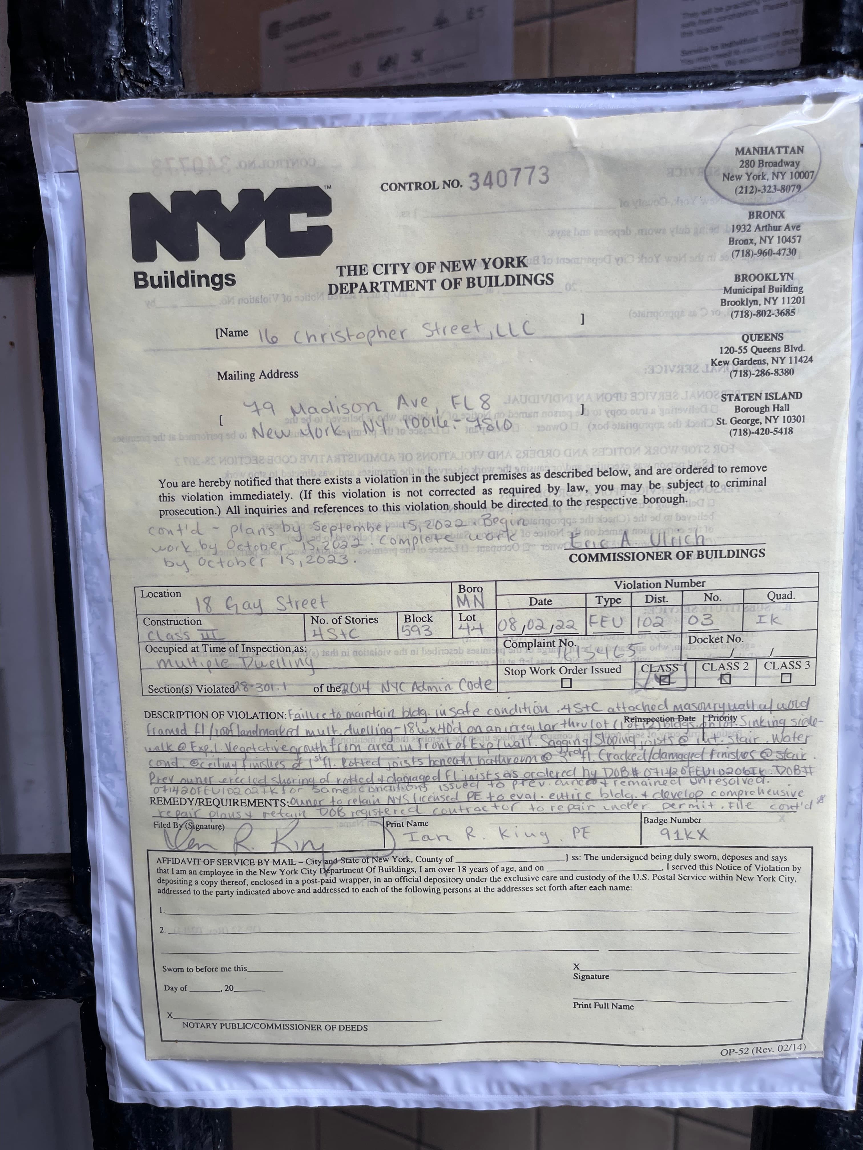 NYC Department of Buildings Notice of Violation dated August 2, 2022 taped to the front door of 18 Gay Street, photographed August 9, 2022