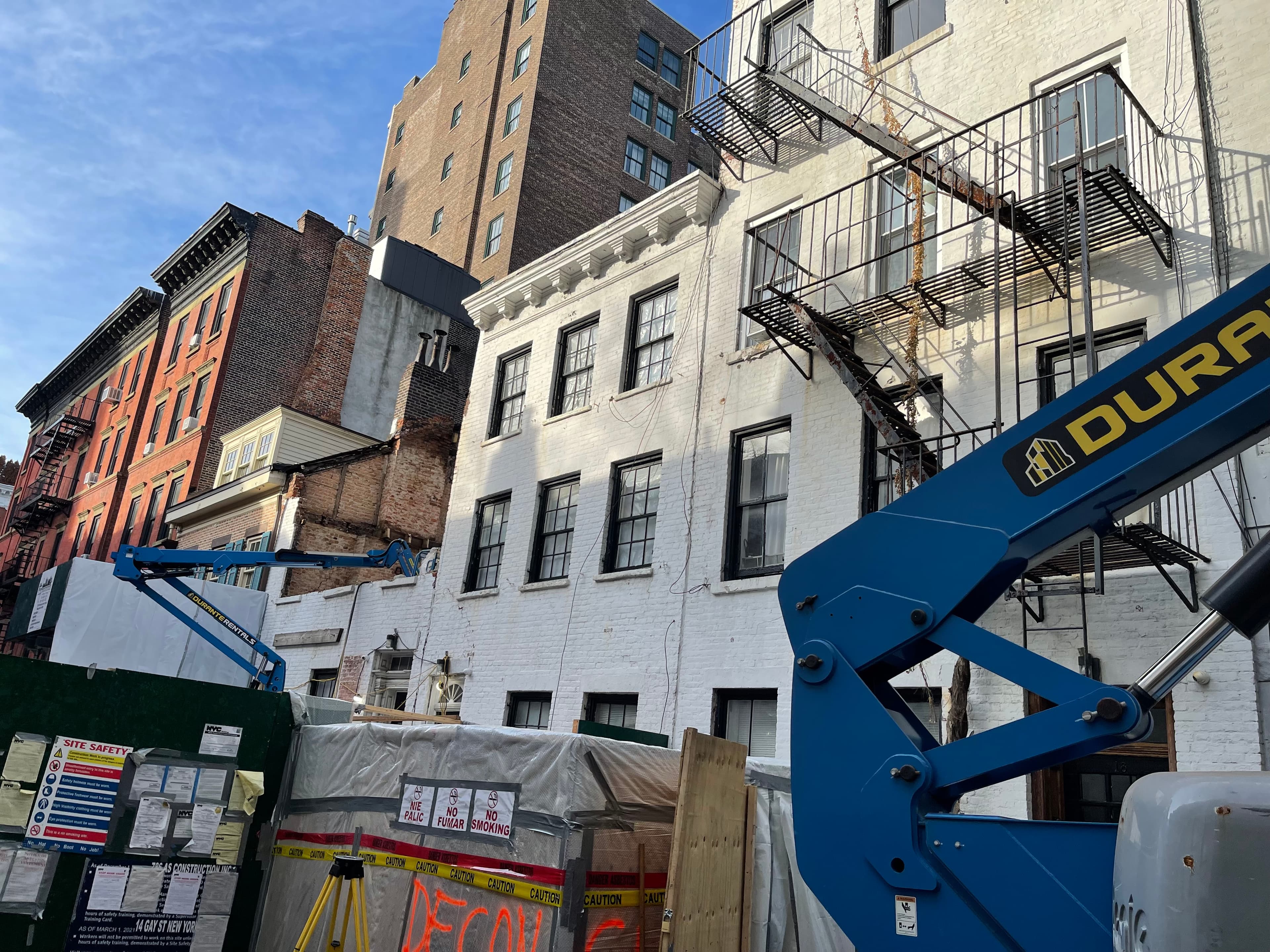 An excavator tearing at 14 Gay Street behind construction fencing and posted permits, demolition underway, December 21, 2022