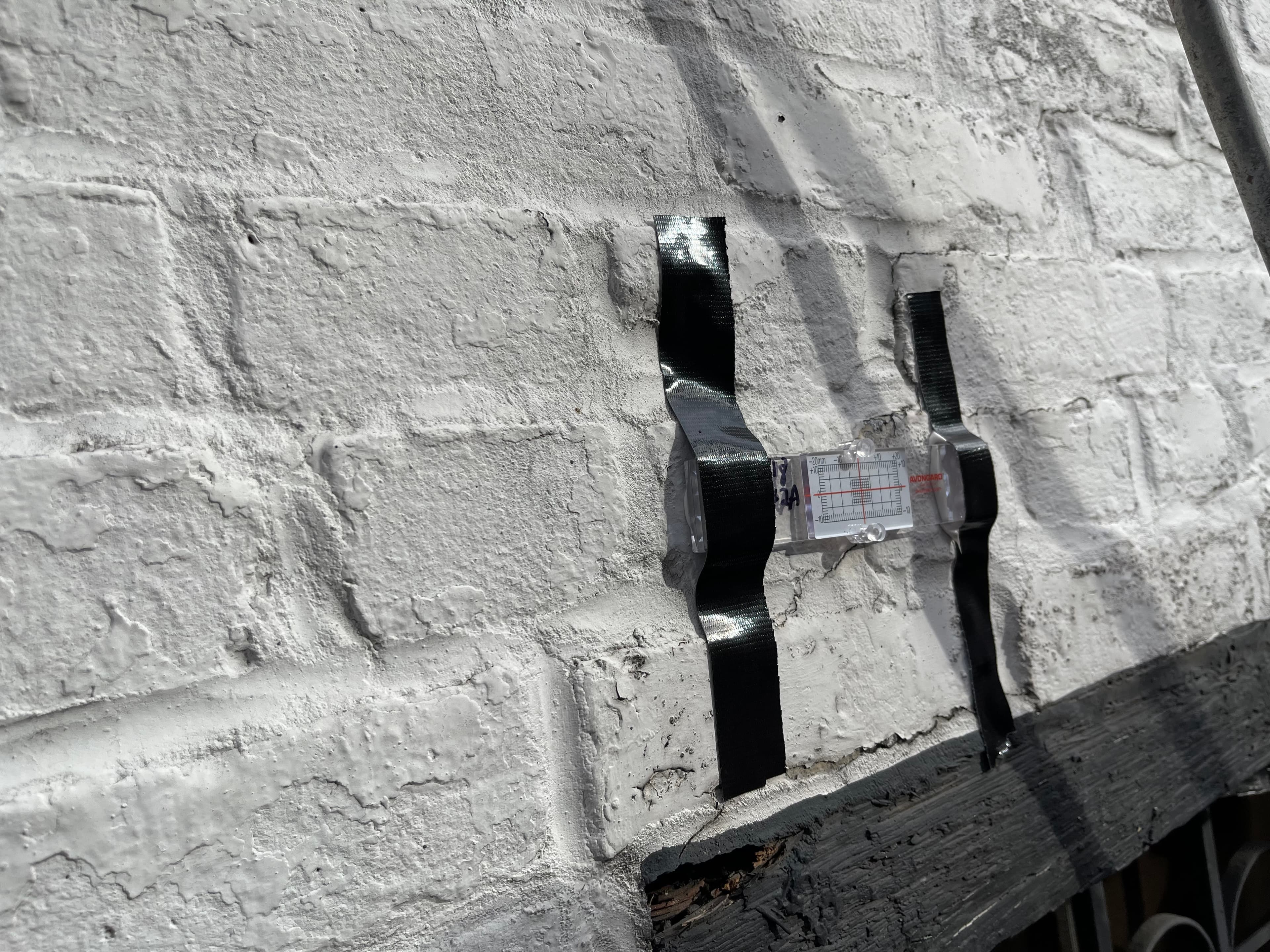 Crack-monitoring gauges installed on the wall inside 18 Gay Street, January 20, 2023