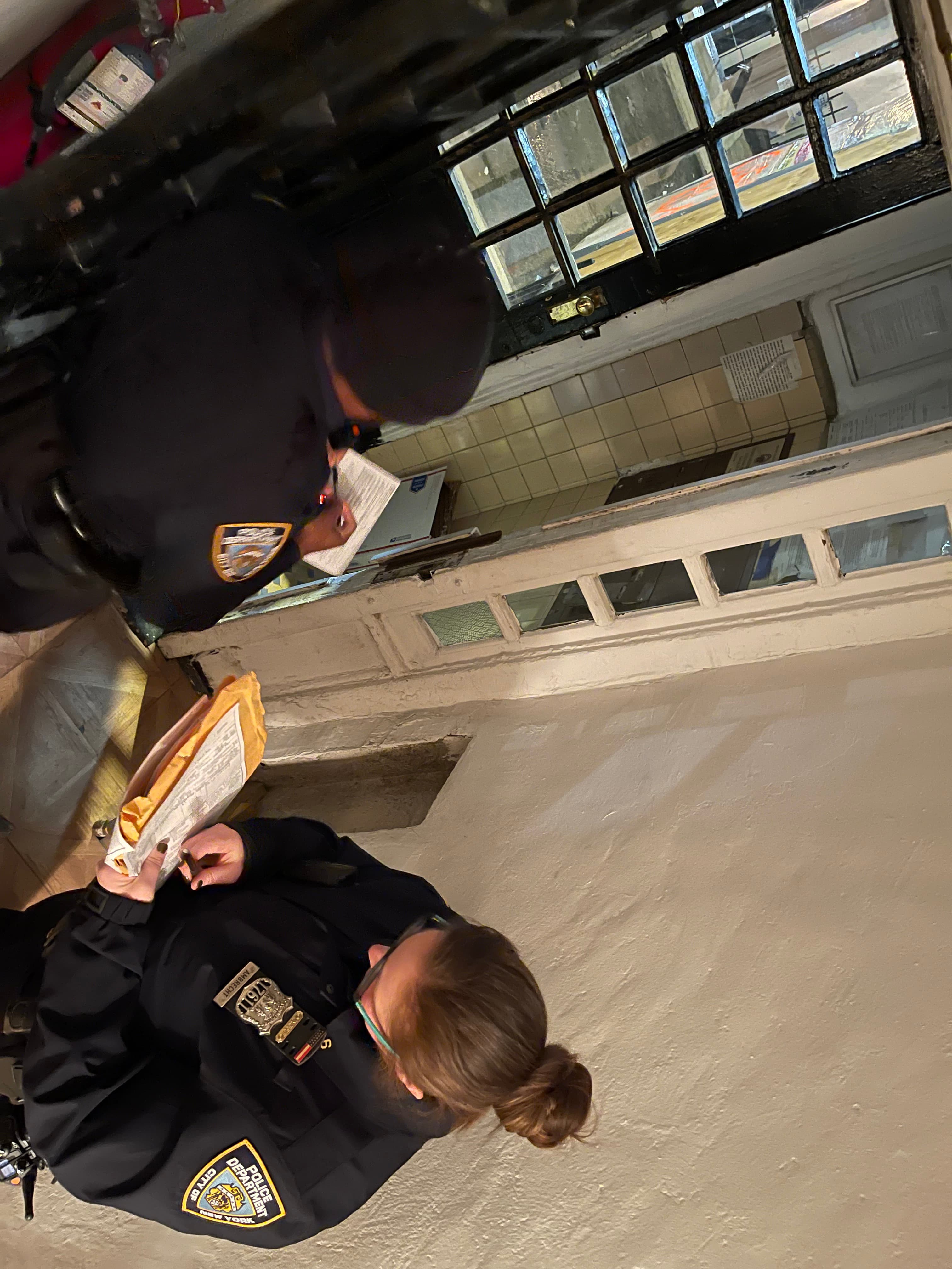 Two NYPD officers inside the 18 Gay Street vestibule after the reported break-in and medication theft, January 23, 2023