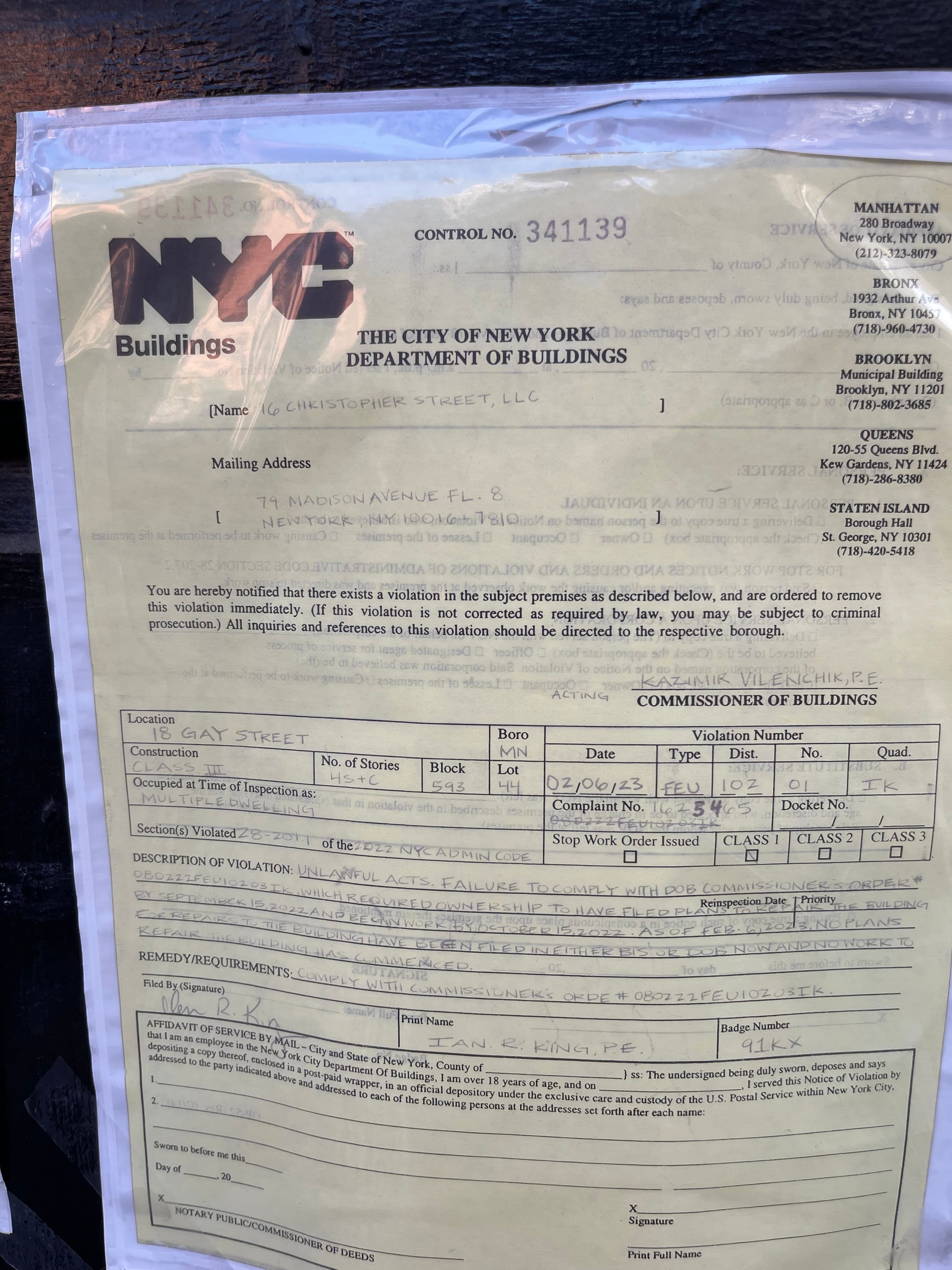 NYC Department of Buildings Notice of Violation dated February 6, 2023 taped to the front door of 18 Gay Street, photographed February 24, 2023