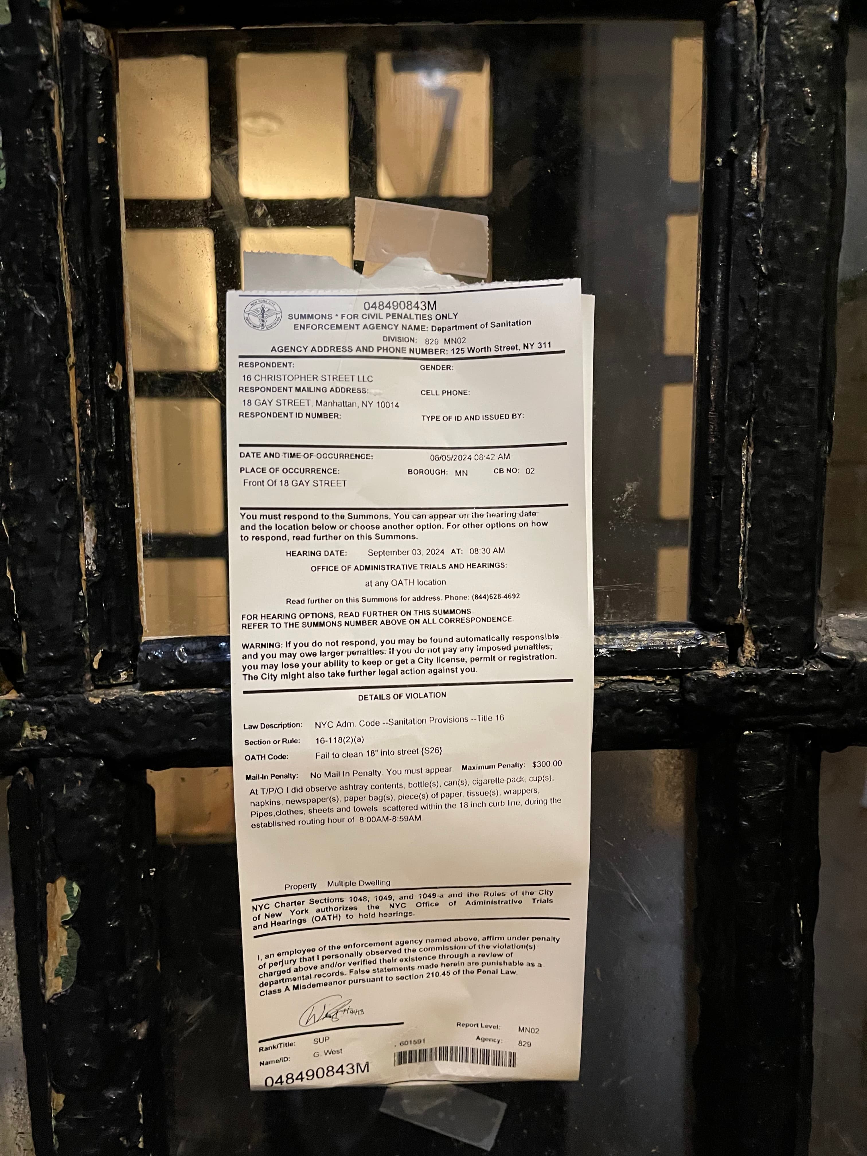 A Department of Sanitation summons taped to the front door of 18 Gay Street, issued to 16 Christopher Street LLC on June 5, 2024, for refuse scattered within the eighteen-inch curb line