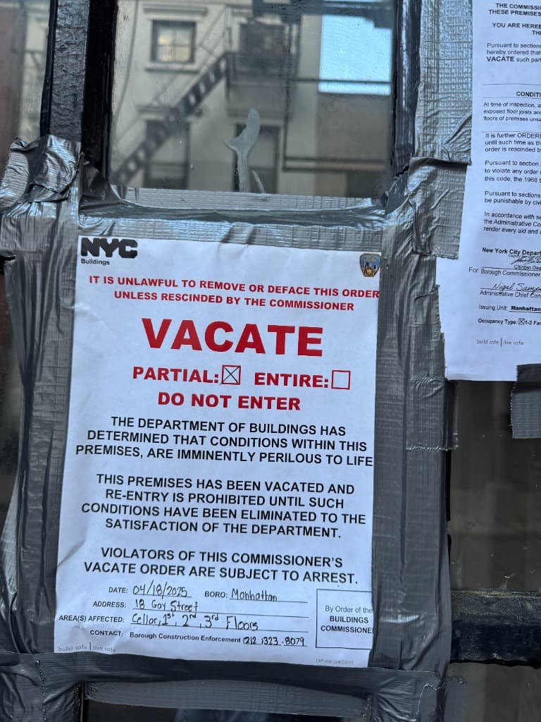 DOB partial vacate order posted on the door of 18 Gay Street — dated April 18, 2025, covering the cellar through third floors, warning that violators are subject to arrest
